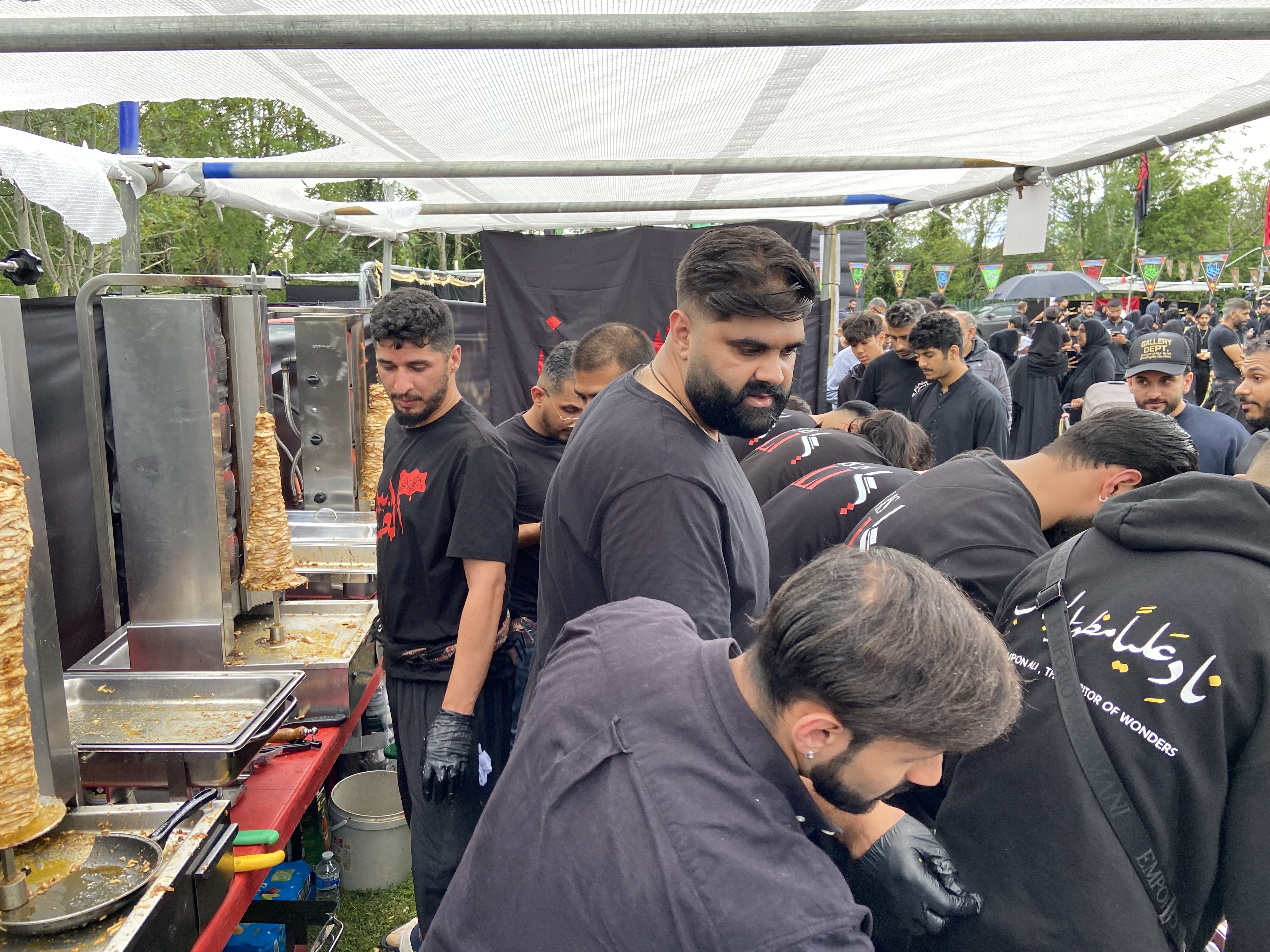 TIA volunteers preparing food at a community service event.