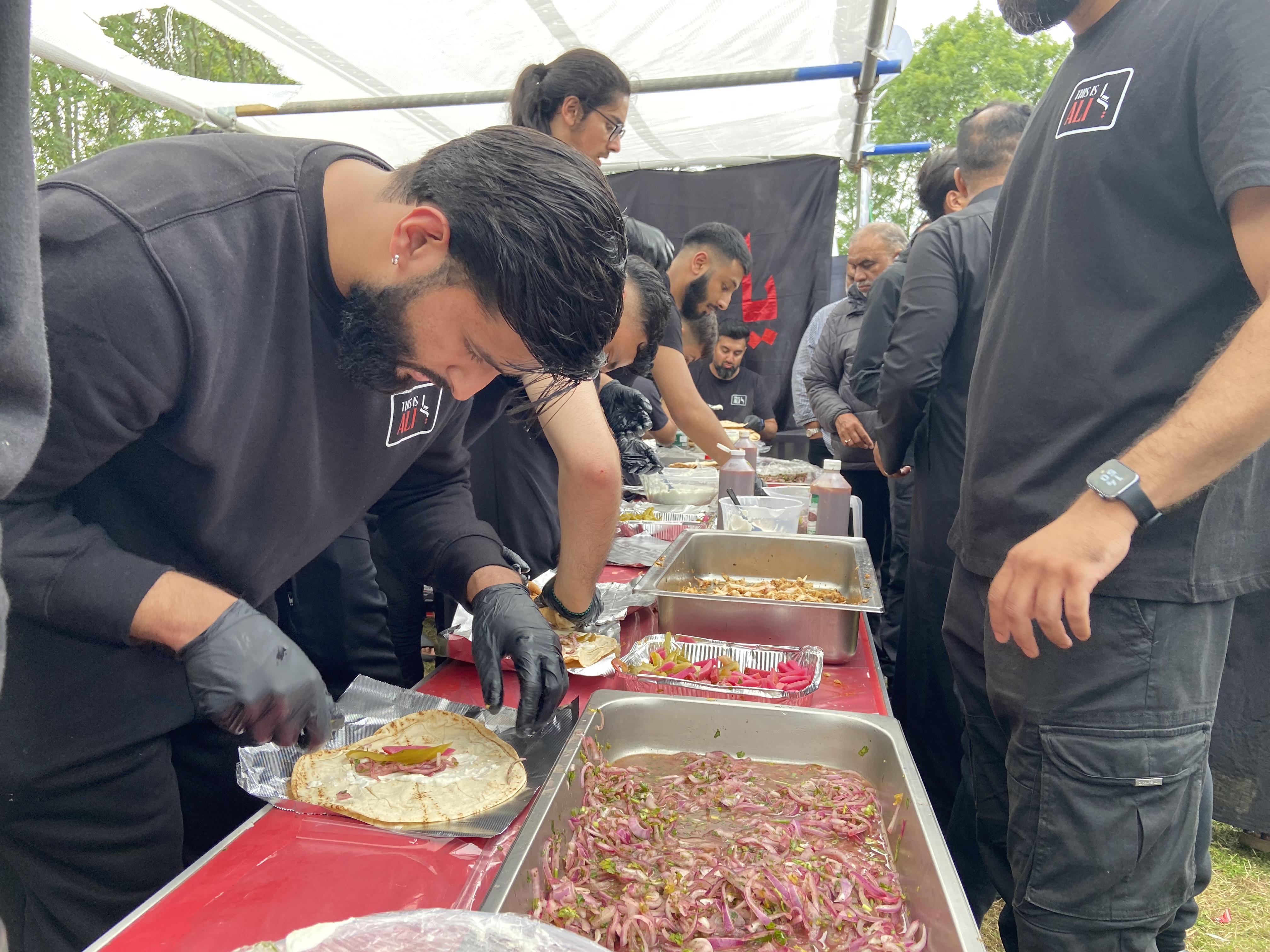TIA volunteers preparing meals for service.